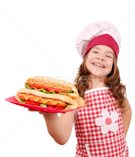 Stock photo: happy little girl cook with hot dogs 