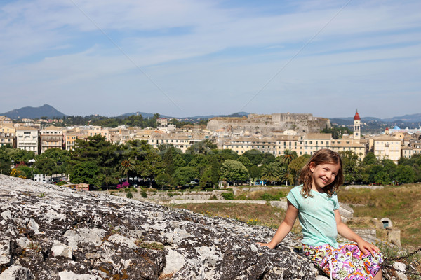 happy little girl sitting on stone wall Corfu town Stock photo © goce