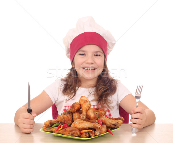 little girl cook with chicken drumstick on plate ready for lunch Stock photo © goce