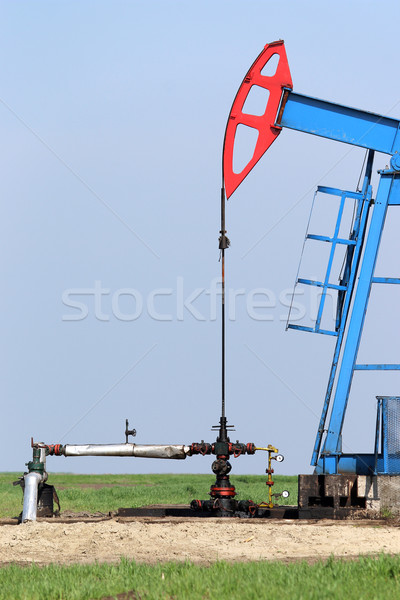 Stock photo: oil pump jack and valve with pipeline