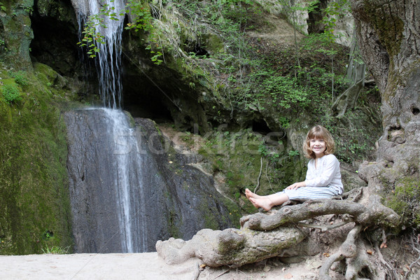 little girl sitting next to a waterfall Stock photo © goce