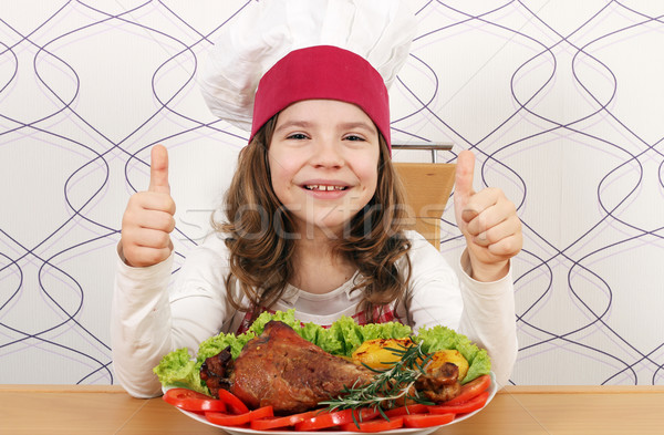 happy little girl cook with big drumstick and thumbs up Stock photo © goce