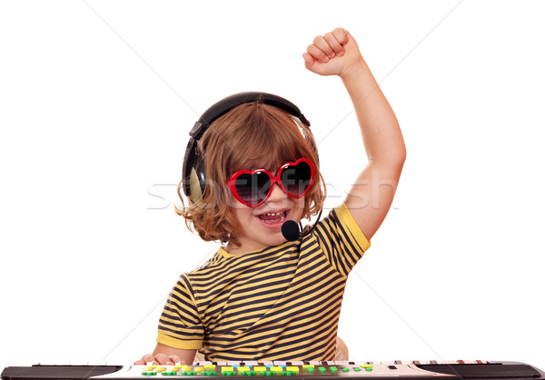 happy little girl play music on keyboard Stock photo © goce