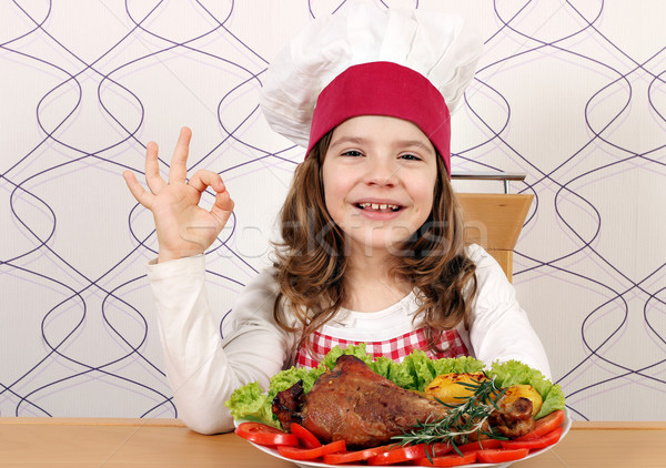 little girl cook with turkey drumstick and ok hand sign Stock photo © goce