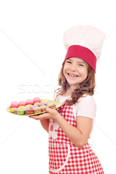 happy little girl cook hold plate with macarons Stock photo © goce