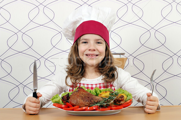 little girl cook with big turkey drumstick on table Stock photo © goce