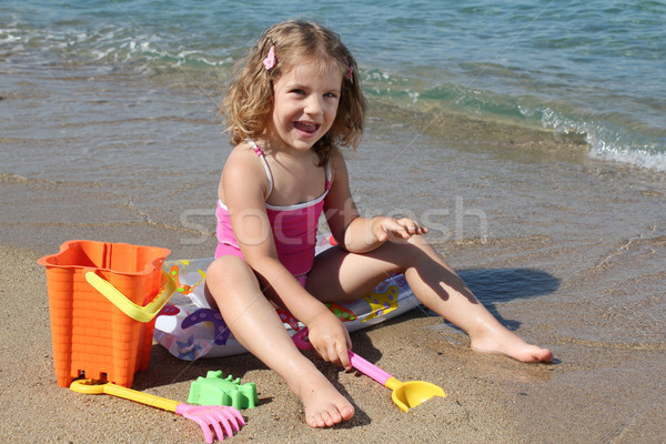 happy little girl playing on beach Stock photo © goce
