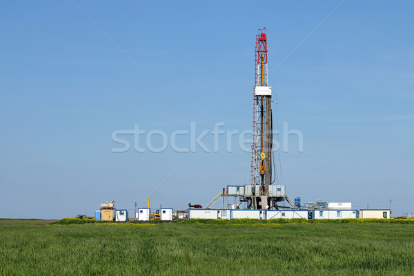 land oil drilling rig on green wheat field Stock photo © goce