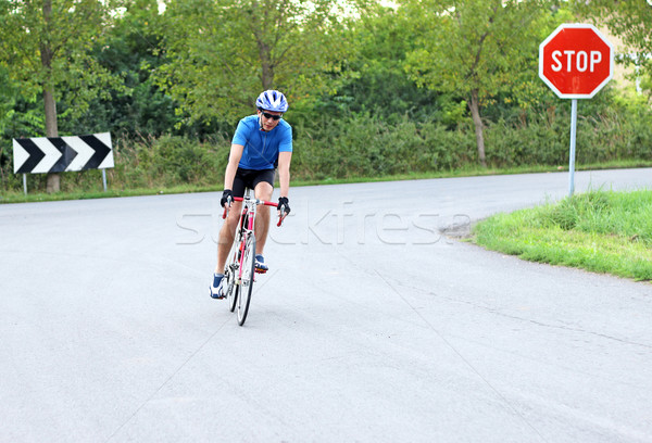 male cyclist riding a bike on an road Stock photo © goce