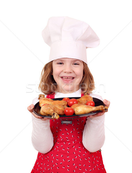 happy little girl cook hold dish with chicken drumstick Stock photo © goce