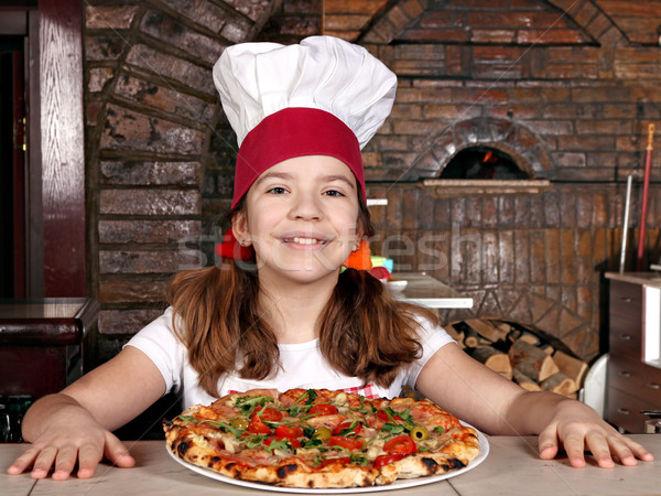 happy little girl cook with pizza in pizzeria Stock photo © goce