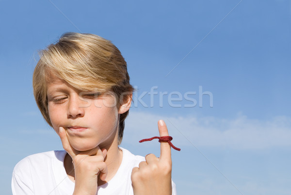 forgetful kid with string tied on finger as a reminder. Stock photo © godfer