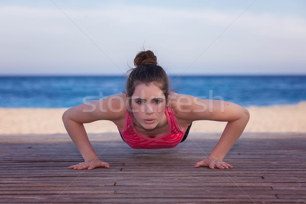 fit woman doing push up or press up Stock photo © godfer