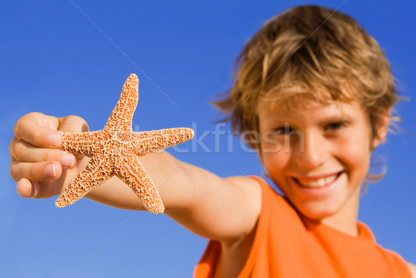 summer child focus on starfish Stock photo © godfer