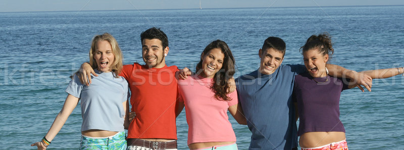 group of teens goofing on beach vaction in summer or spring break Stock photo © godfer