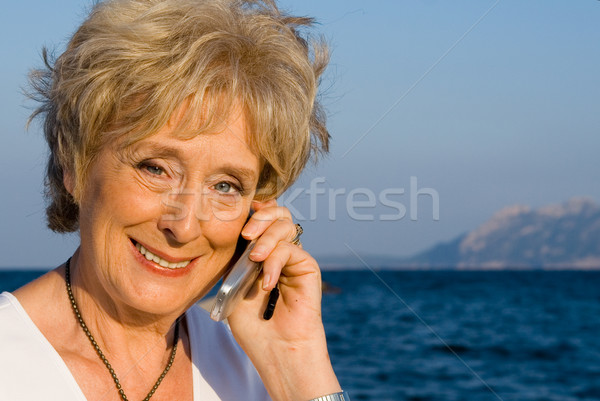 senior woman with cell or mobile phone Stock photo © godfer