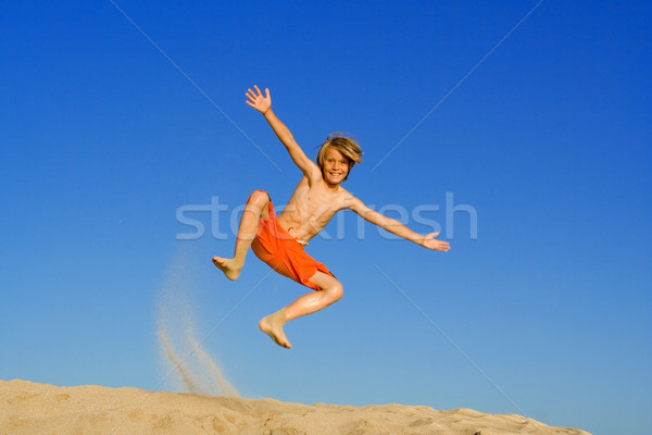 child jumping and playing on beach summer vacation or holiday Stock photo © godfer