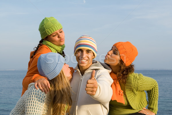 happy boy surrounded by girls blowing kisses Stock photo © godfer