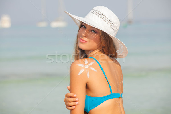 concept for safe sunbathing, woman with sun cream Stock photo © godfer