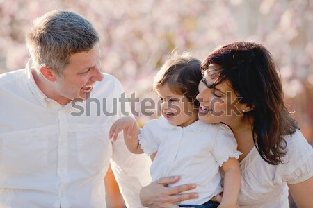 family, mother father and daughter blowing bubbles Stock photo © godfer