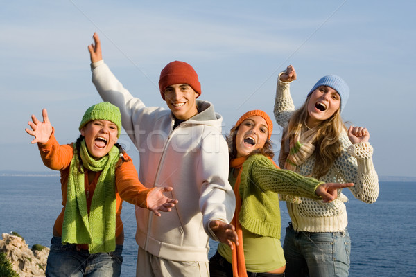 Stock photo: group of happy smiling teens, singing or shouting