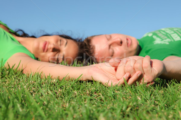 sleeping couple , focus on holding hands, Stock photo © godfer