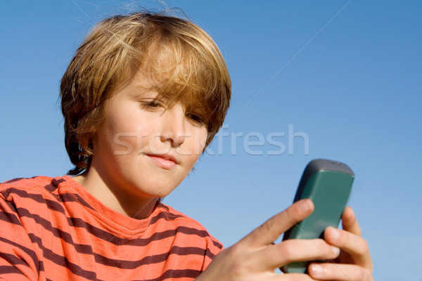 kid texting with cell or mobile phone Stock photo © godfer