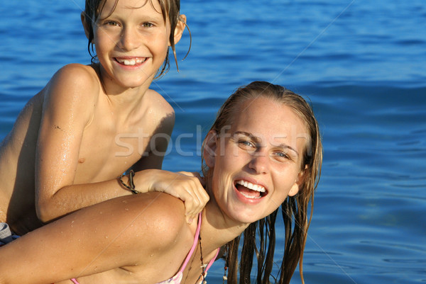 young family, mother and son playing on beach on summer holiday or vacation Stock photo © godfer