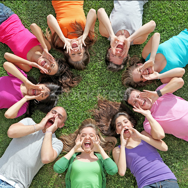 Stock photo: group of kids or teens shouting or singing at summer camp