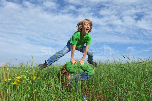 happy healthy kids playing leapfrog outdoors in summer Stock photo © godfer