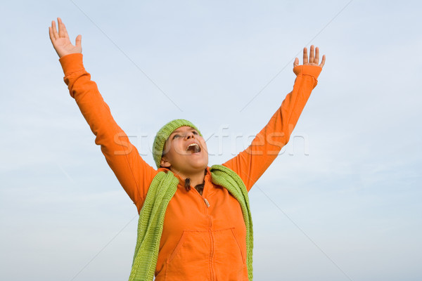 kid with arms raised singing or faith and praise Stock photo © godfer