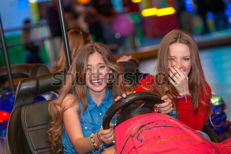 kids at fair ground riding bumper cars Stock photo © godfer