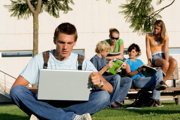 students with laptops and book on campus Stock photo © godfer
