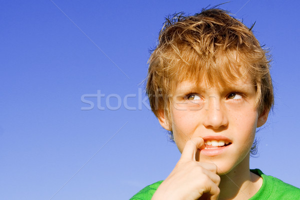Stock photo: curious, puzzled shy or scared kid or child finger in mouth