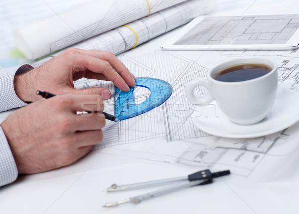 Reviewing a blueprint on table Stock photo © goir