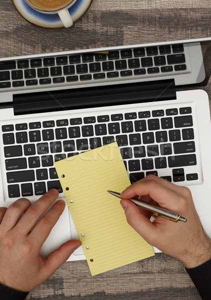 Man at desk taking notes Stock photo © goir