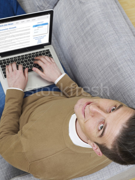 Relaxing on sofa with laptop Stock photo © goir