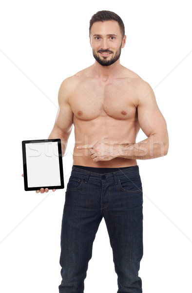 Muscular man pointing to a digital tablet Stock photo © goir