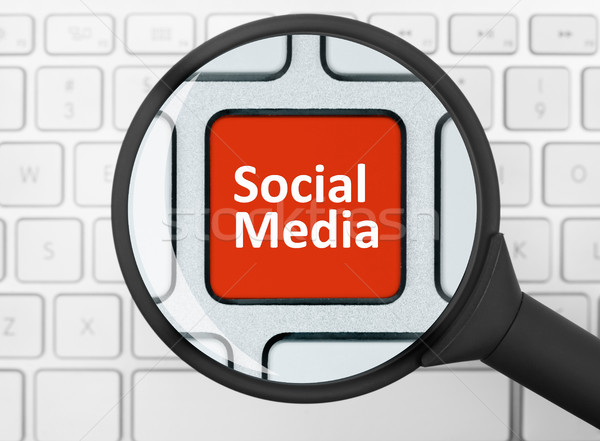 Stock photo: Social media button under the magnifying glass