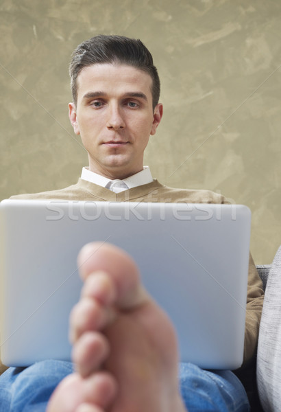 Relaxed man working on laptop Stock photo © goir