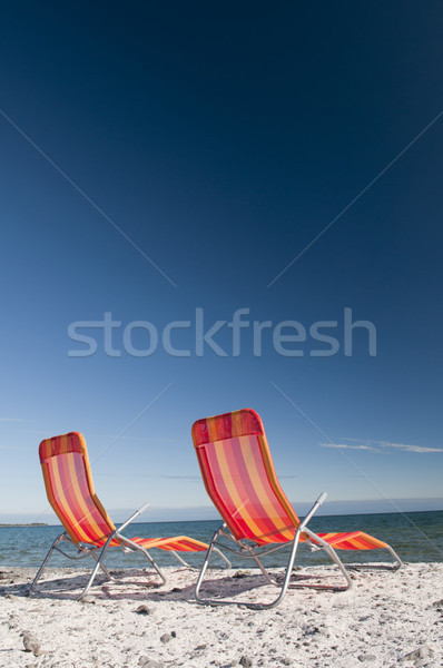 Beach Chairs on Lake Shoreline Stock photo © Gordo25