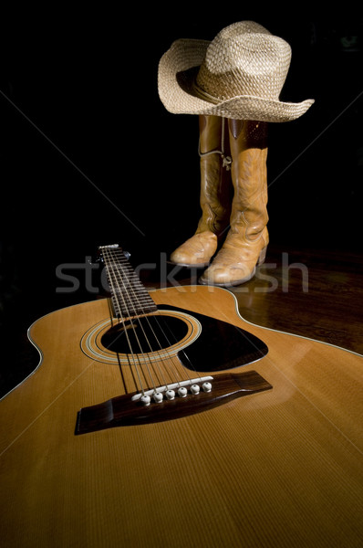 Chitarra stivali da cowboy riflettori primo piano messa a fuoco selettiva legno Foto d'archivio © Gordo25