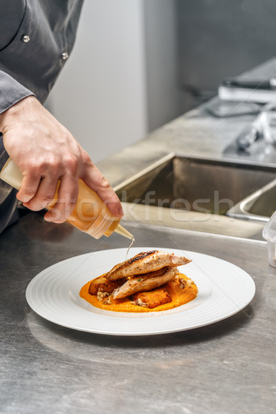 Chef decorating dinner plate Stock photo © grafvision