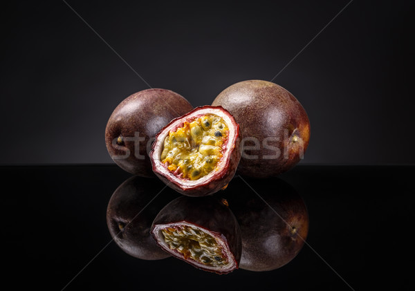 Whole and half passion fruits Stock photo © grafvision