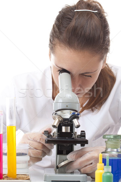 Stock photo: Woman working with a microscope