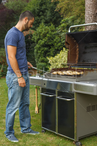 Fiatalember főzés barbecue grill étel tűz fű Stock fotó © grafvision