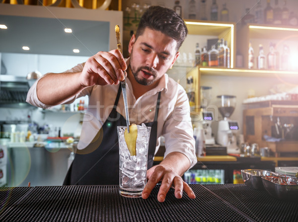 Bartender adding ginger into a glass Stock photo © grafvision