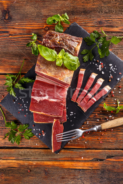 Prosciutto sliced on black slate Stock photo © grafvision