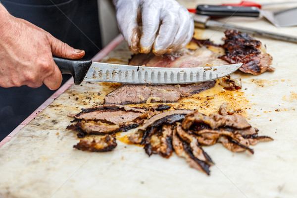Stock photo: Chef slicing grilled beef steak 
