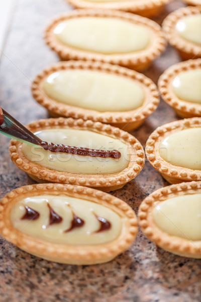 Woman hand decorating mini tarts Stock photo © grafvision